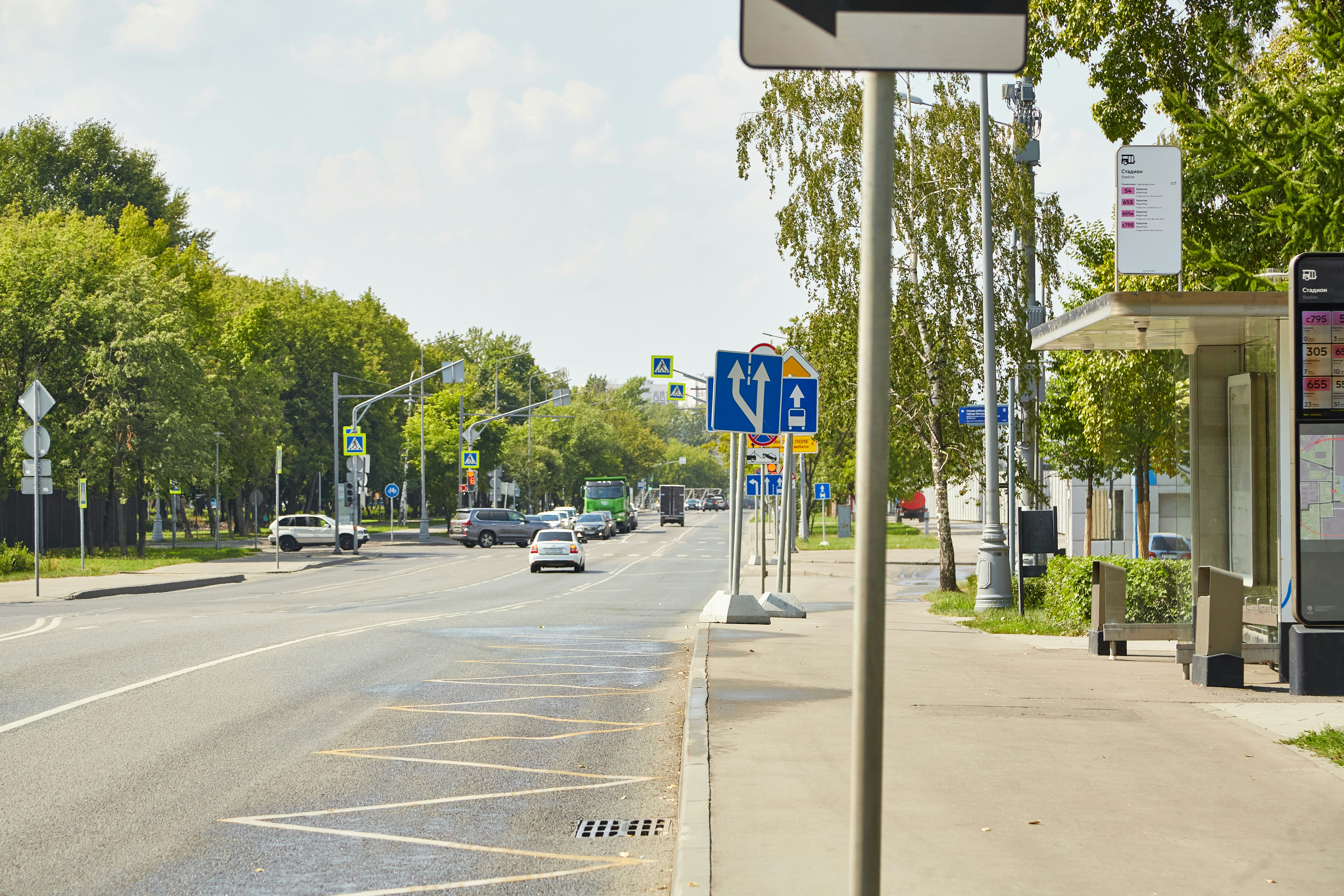 a street with cars and signs