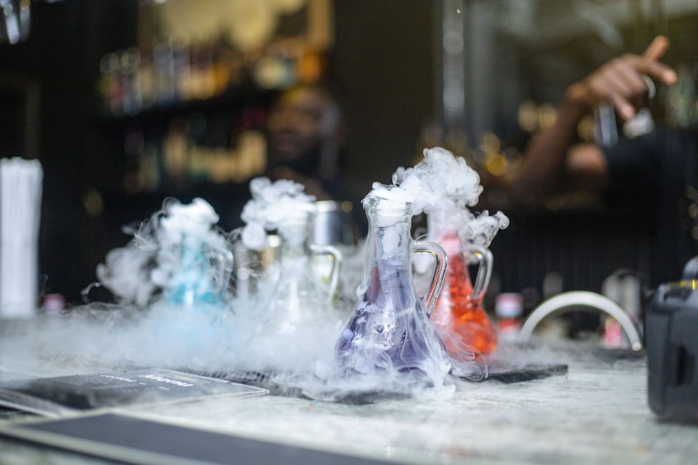 a group of bottles with smoke coming out of them