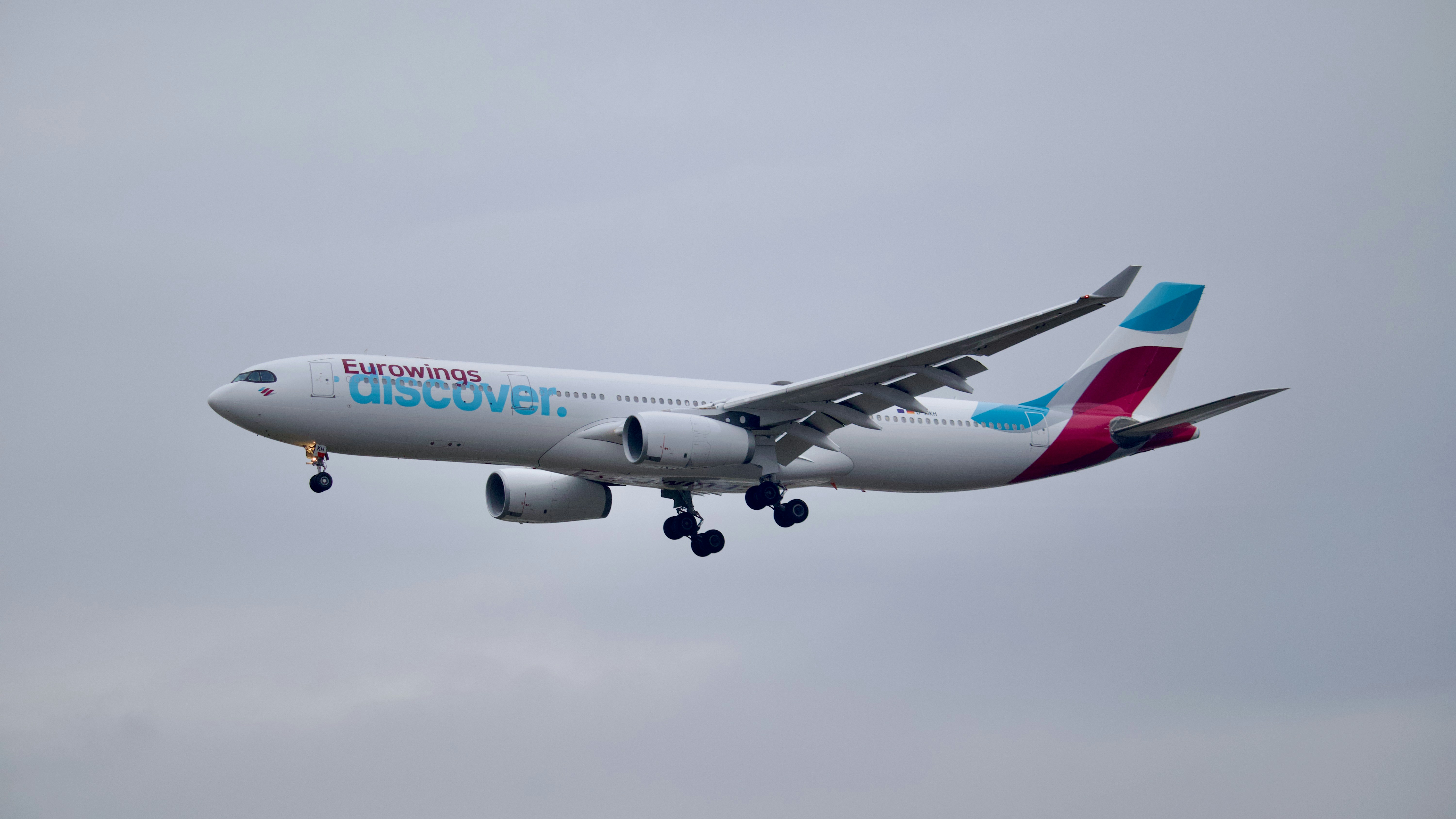 a large airplane flying in the sky, Eurowings Airbus A330 landing at Frankfurt Airport