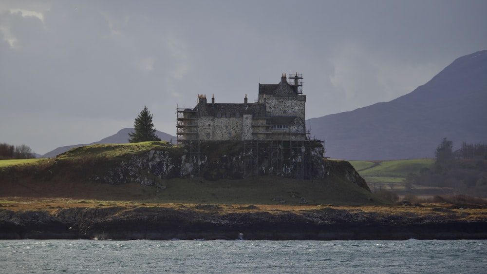 a castle on a hill by the water