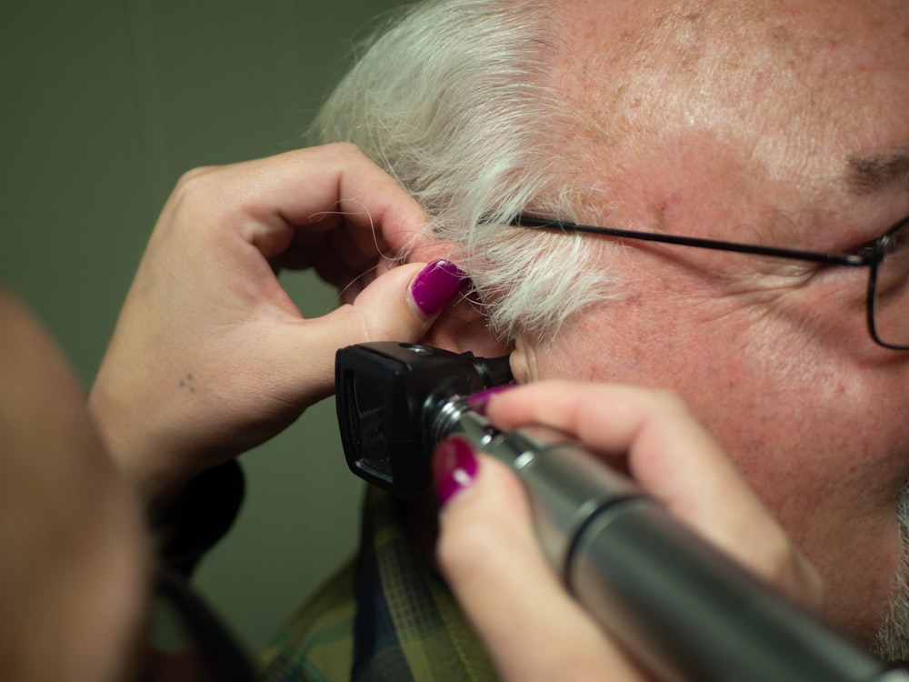 a person holding a phone to the ear