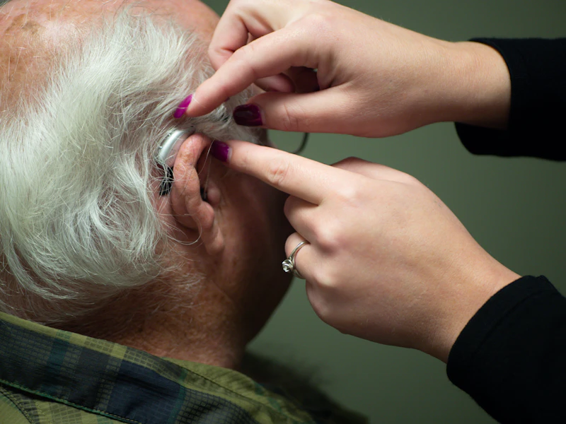 Person experiencing tinnitus distress during hearing check-up