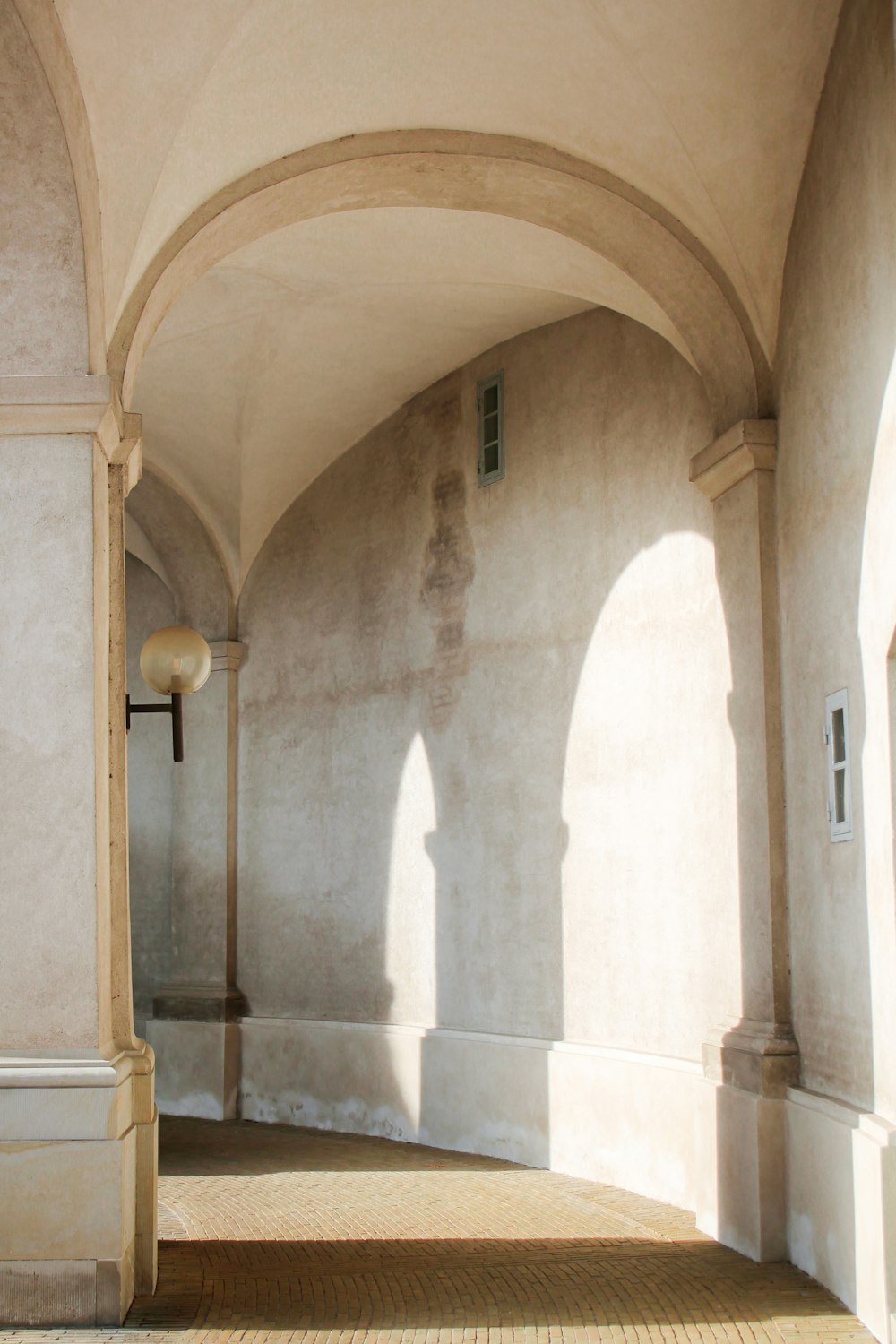 a stone hallway with a light