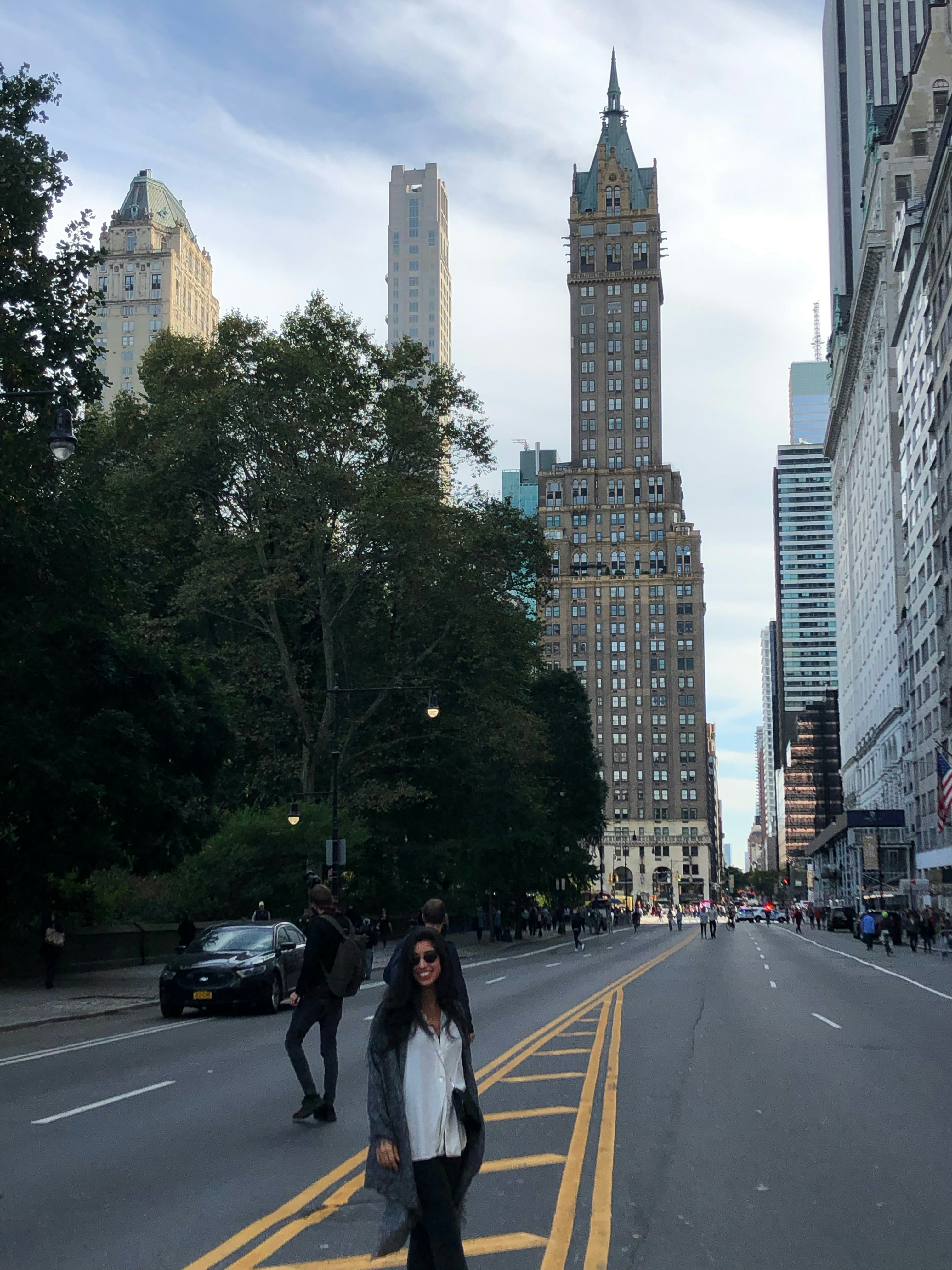 a person standing on a street in front of a tall building