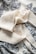 A cotton scarf elegantly draped over a natural stone surface.