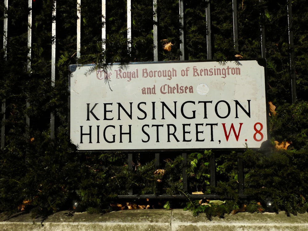 a sign in front of trees