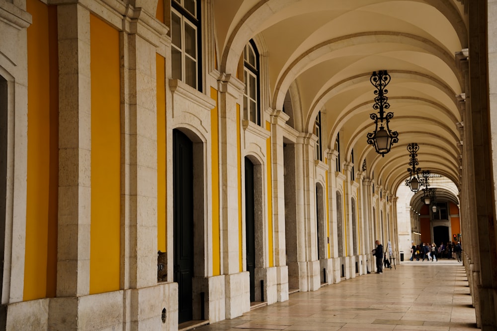 a hallway with yellow and white pillars