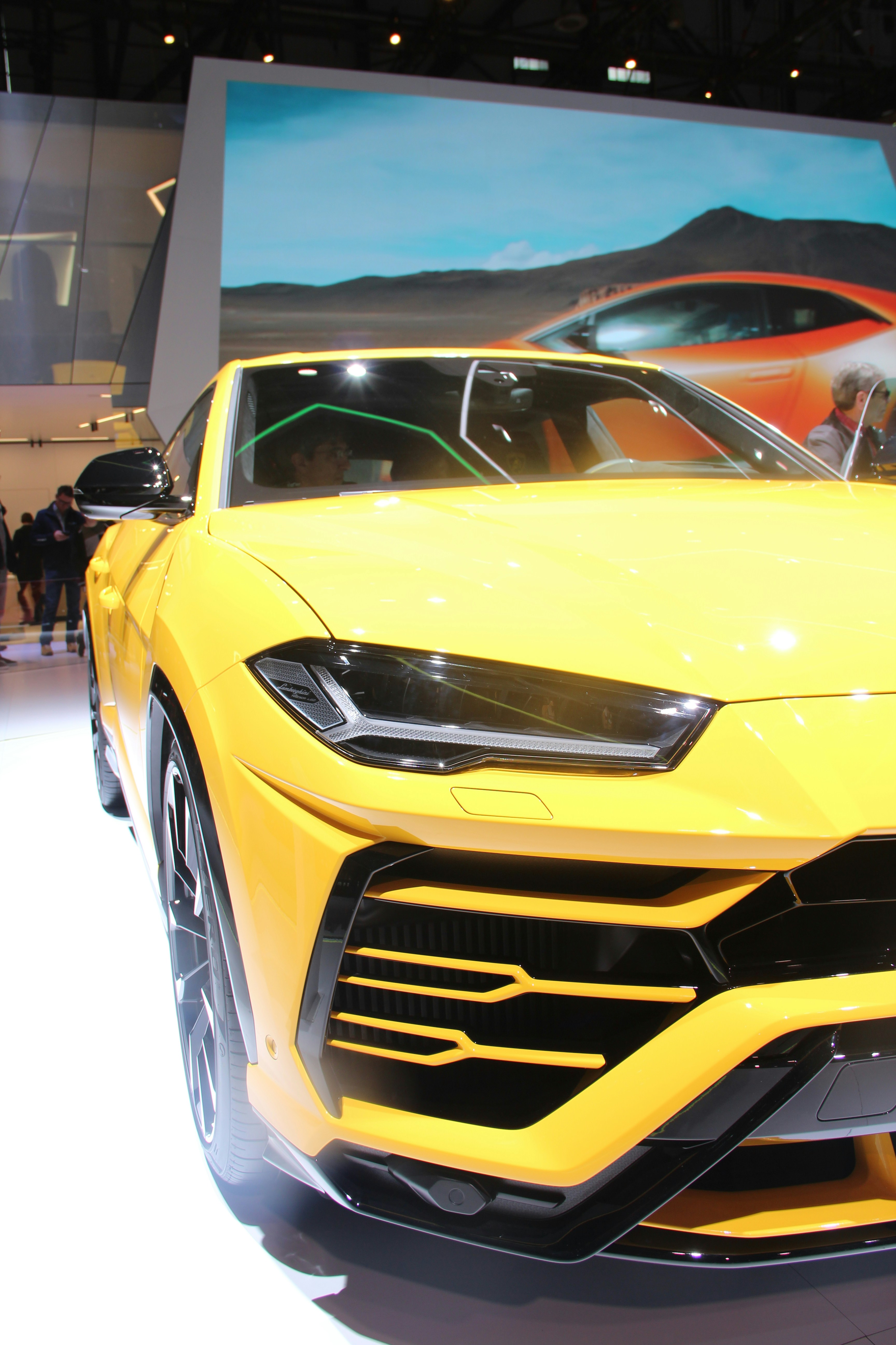 Yellow Lamborghini Huracan on mountain road, dramatic rocky landscape, aggressive Italian supercar