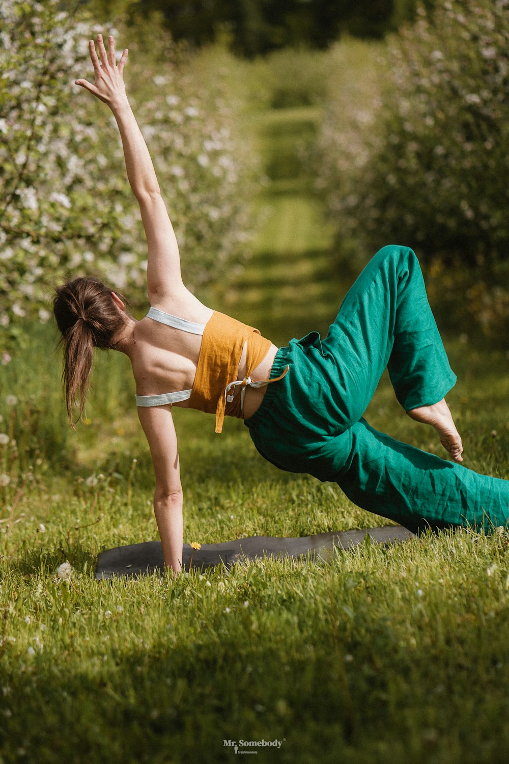 a person doing a handstand on grass