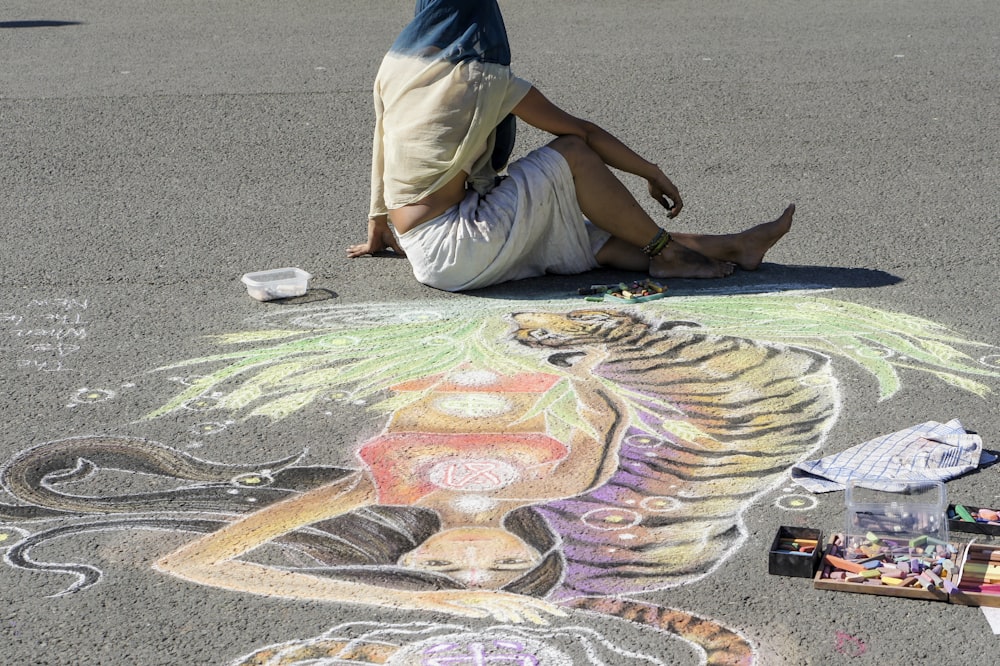 a man painting on the ground