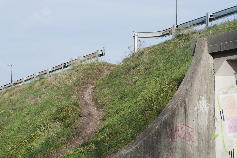 a dirt path between two concrete walls