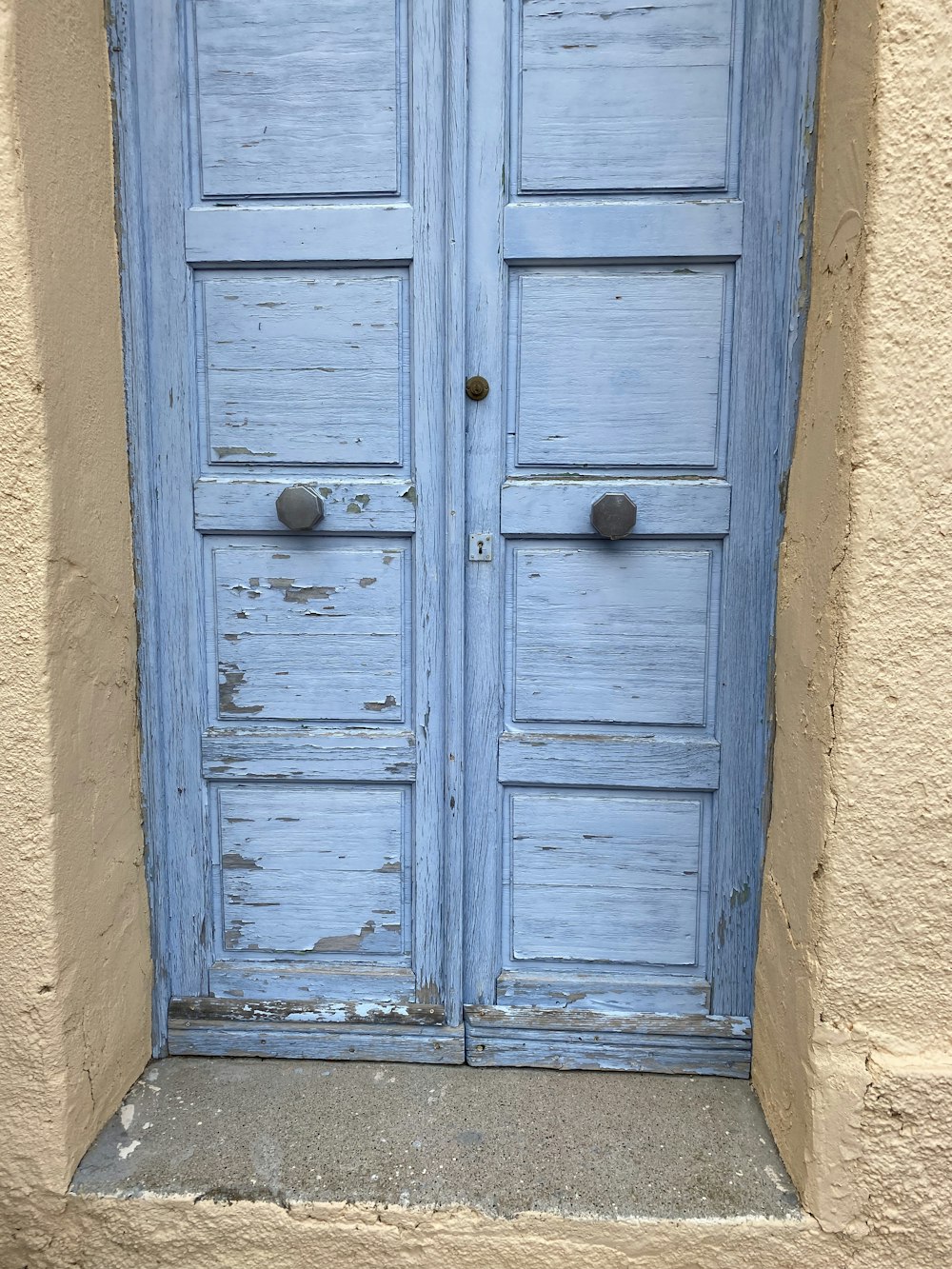 a blue door with a hole in it