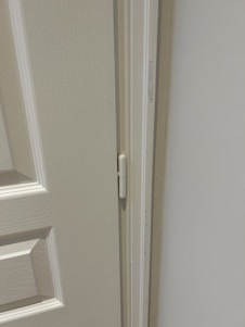 A friendly technician installing a high-quality door with precision and focus.
