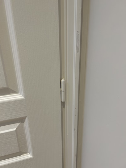 A friendly technician installing a high-quality door with precision and focus.