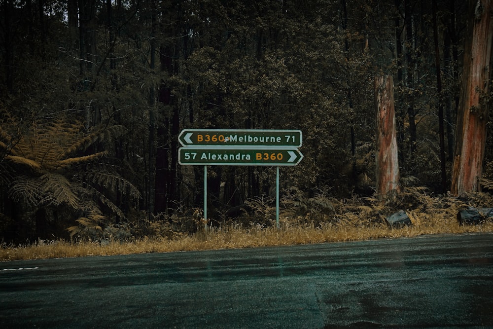 a sign in front of a forest
