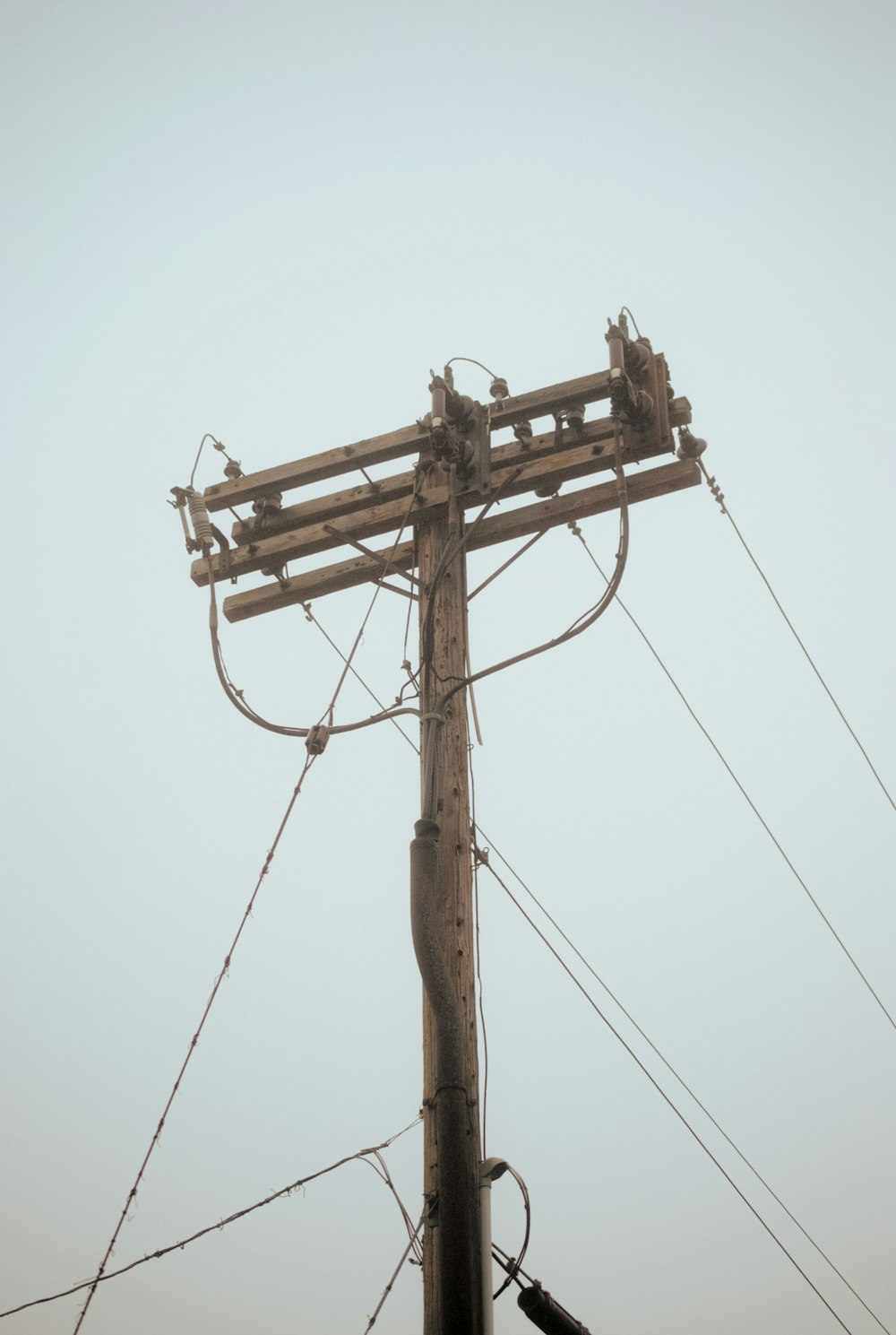 a wooden pole with wires