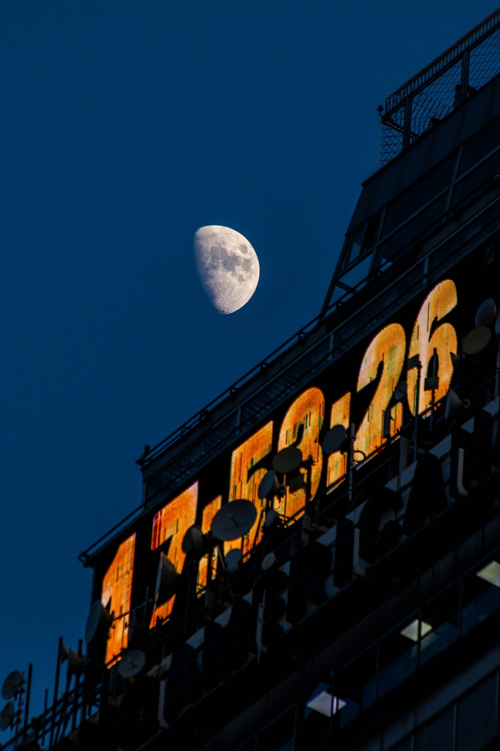 a sign with a moon in the background