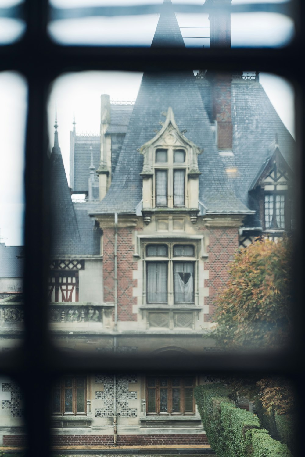 a brick building with a black window