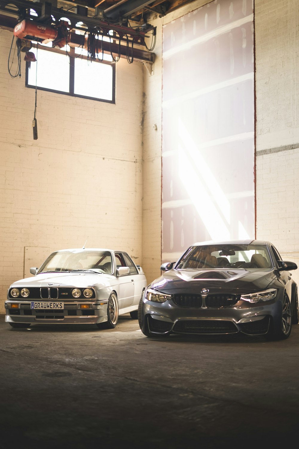 a couple of cars parked in a garage