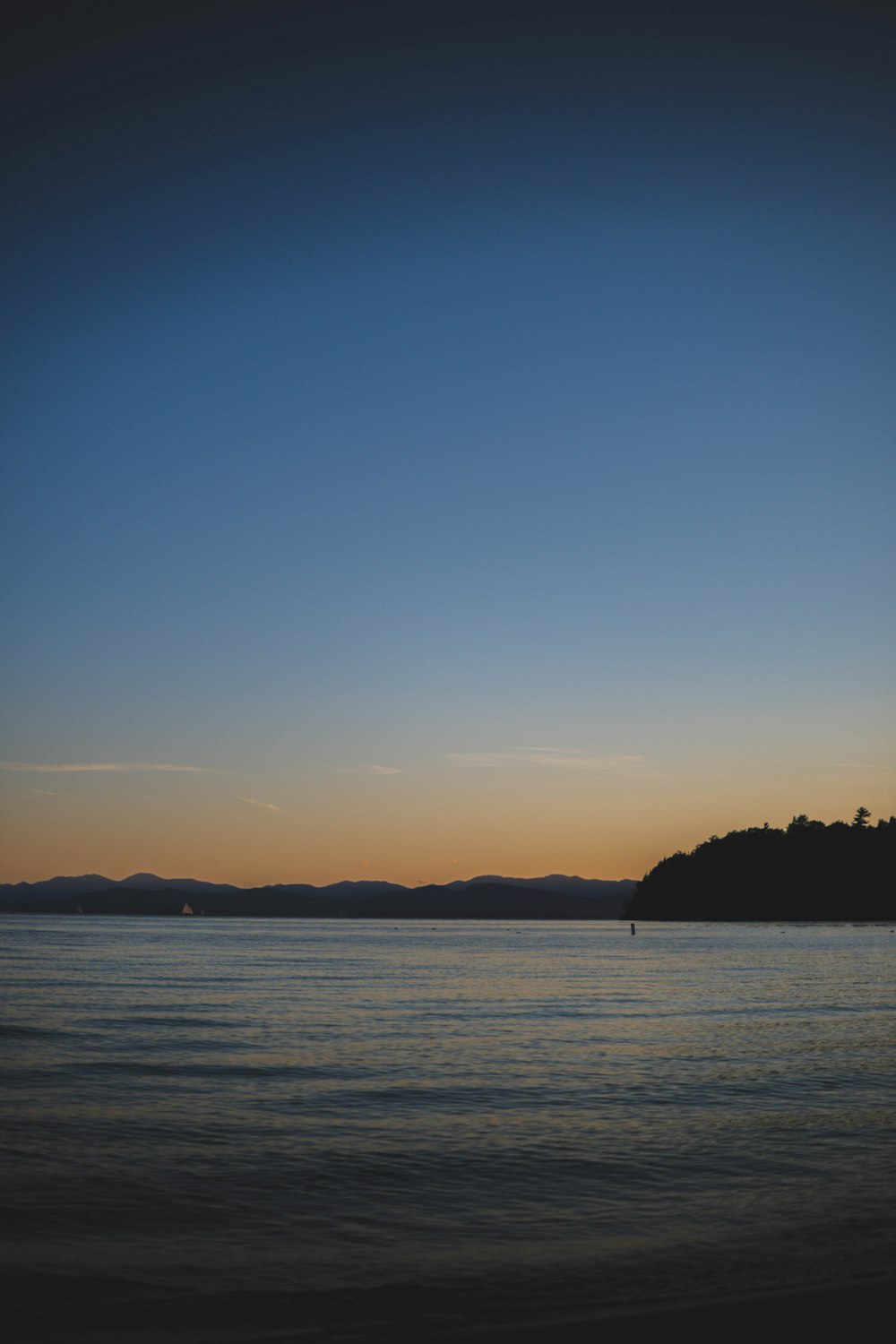 a body of water with hills in the background