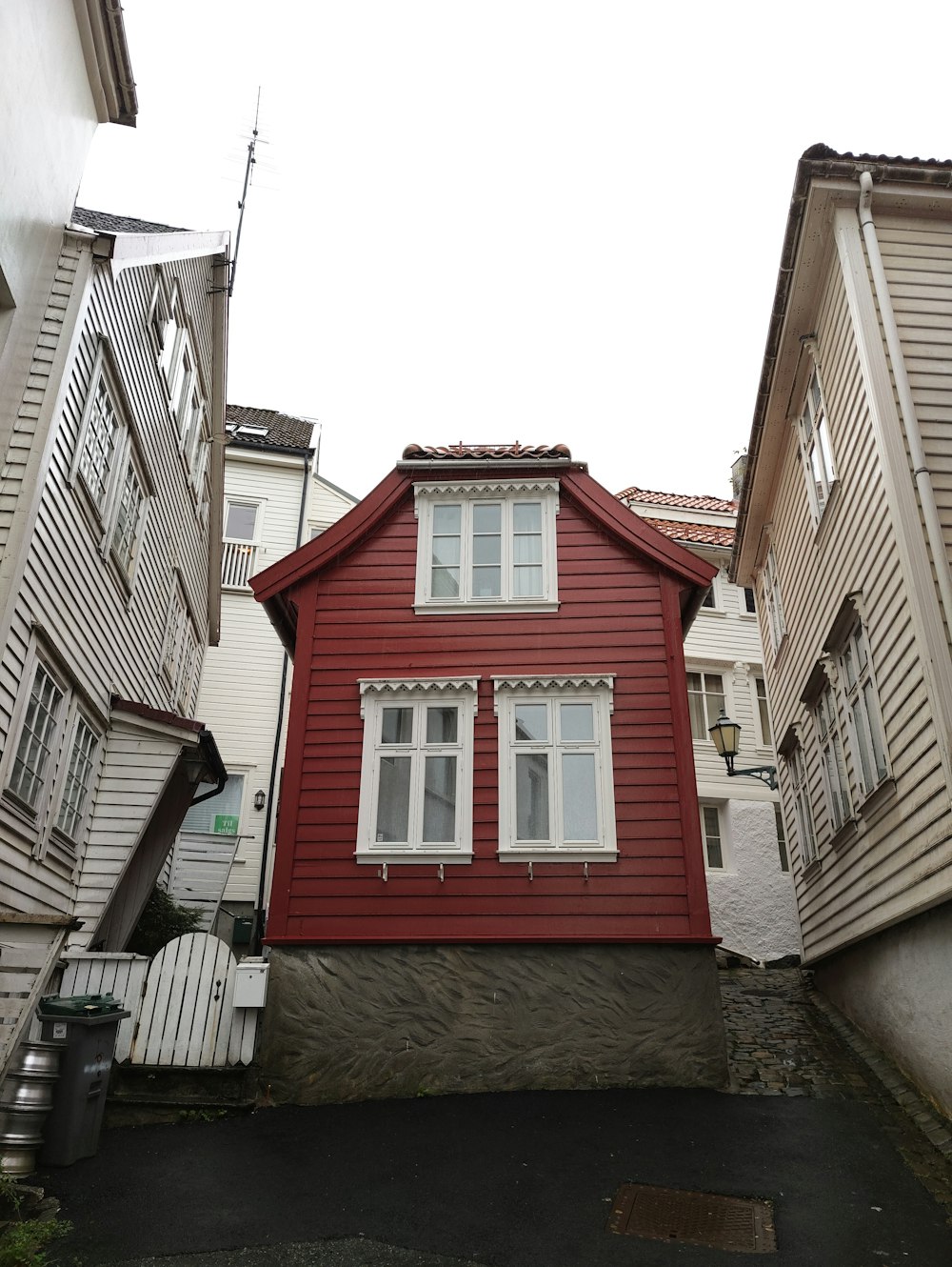 a red house with a white fence