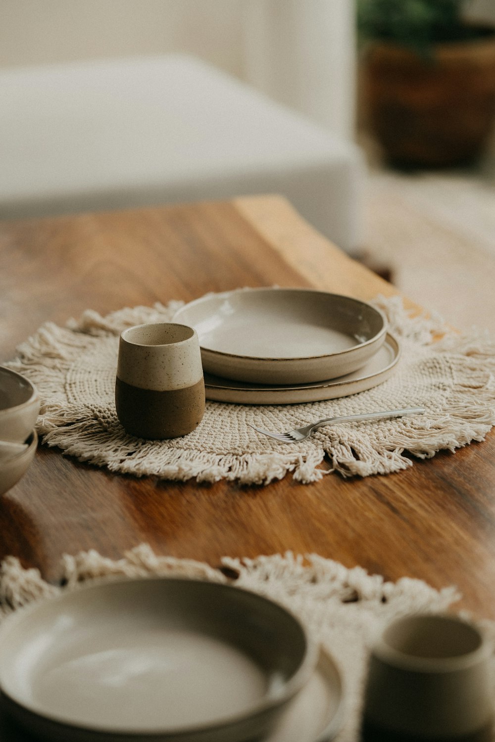 a stack of plates and cups on a table