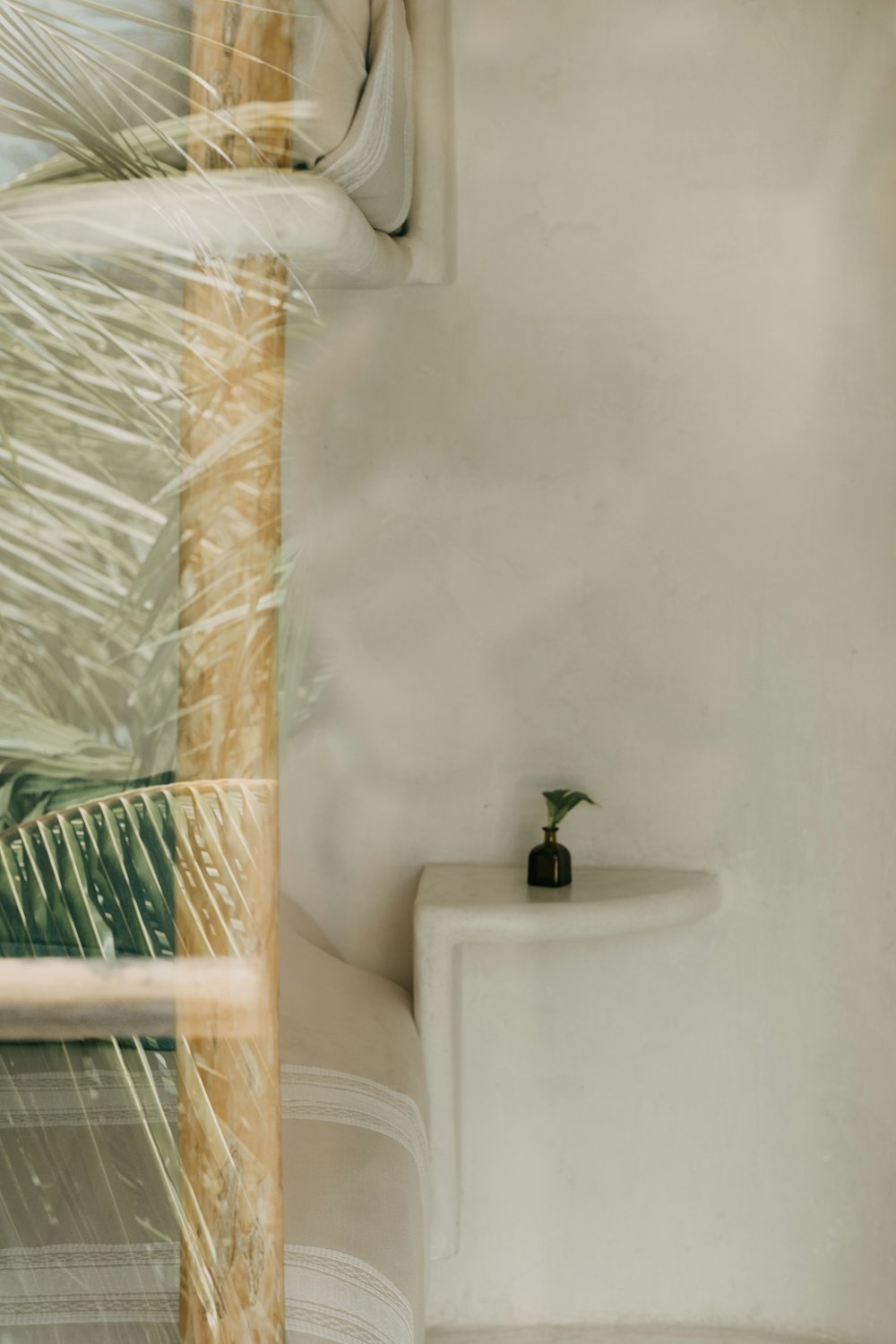 a white sink with a black vase on top