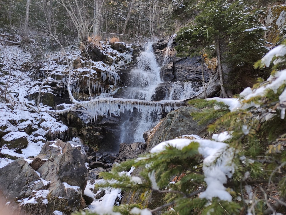 a stream with snow on the sides