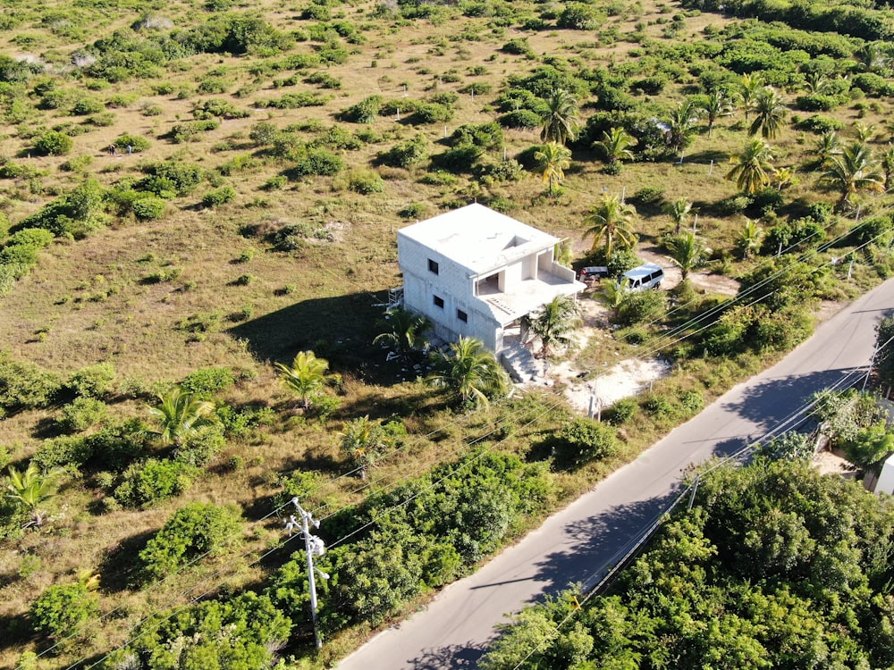 a white house surrounded by trees