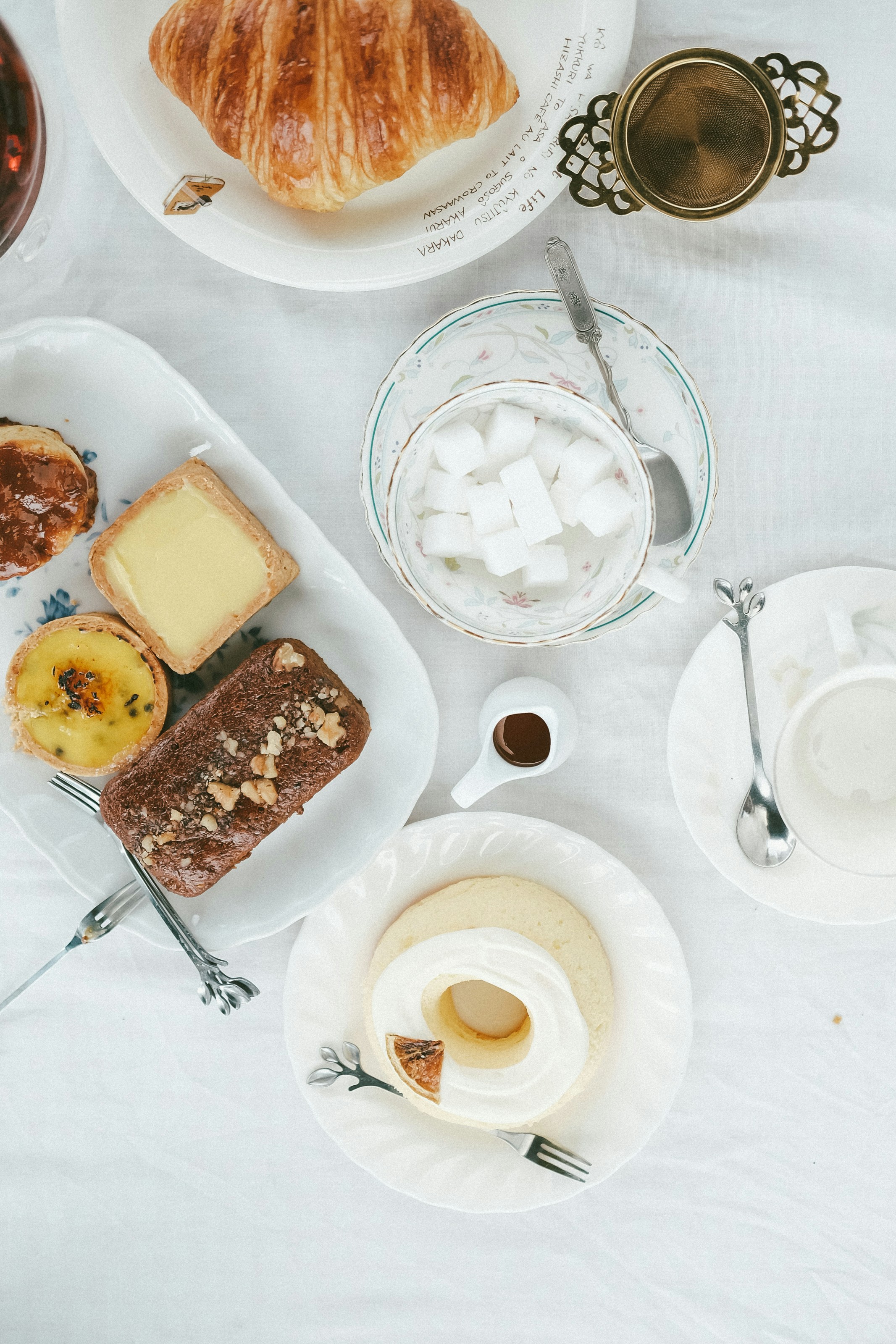 a table with plates of food and cups of liquid