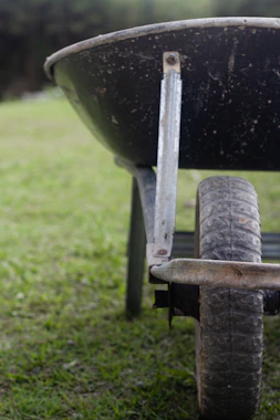 A wheelbarrow on a lawn in the Plovdiv region during a HedgieWilder garden maintenance day.