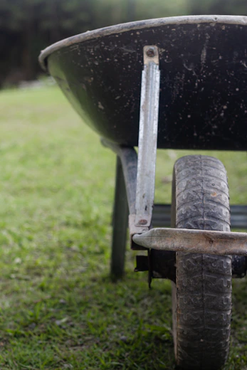 A wheelbarrow on a lawn in the Plovdiv region during a HedgieWilder garden maintenance day.