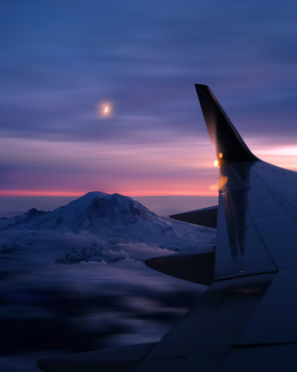 a plane wing and the moon