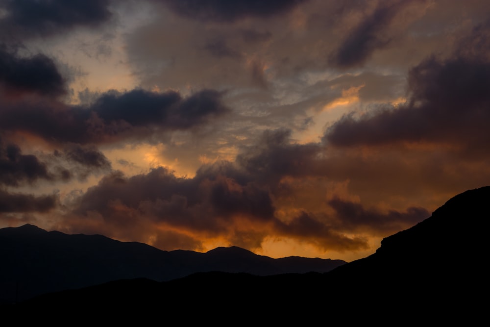 a sunset over a mountain range