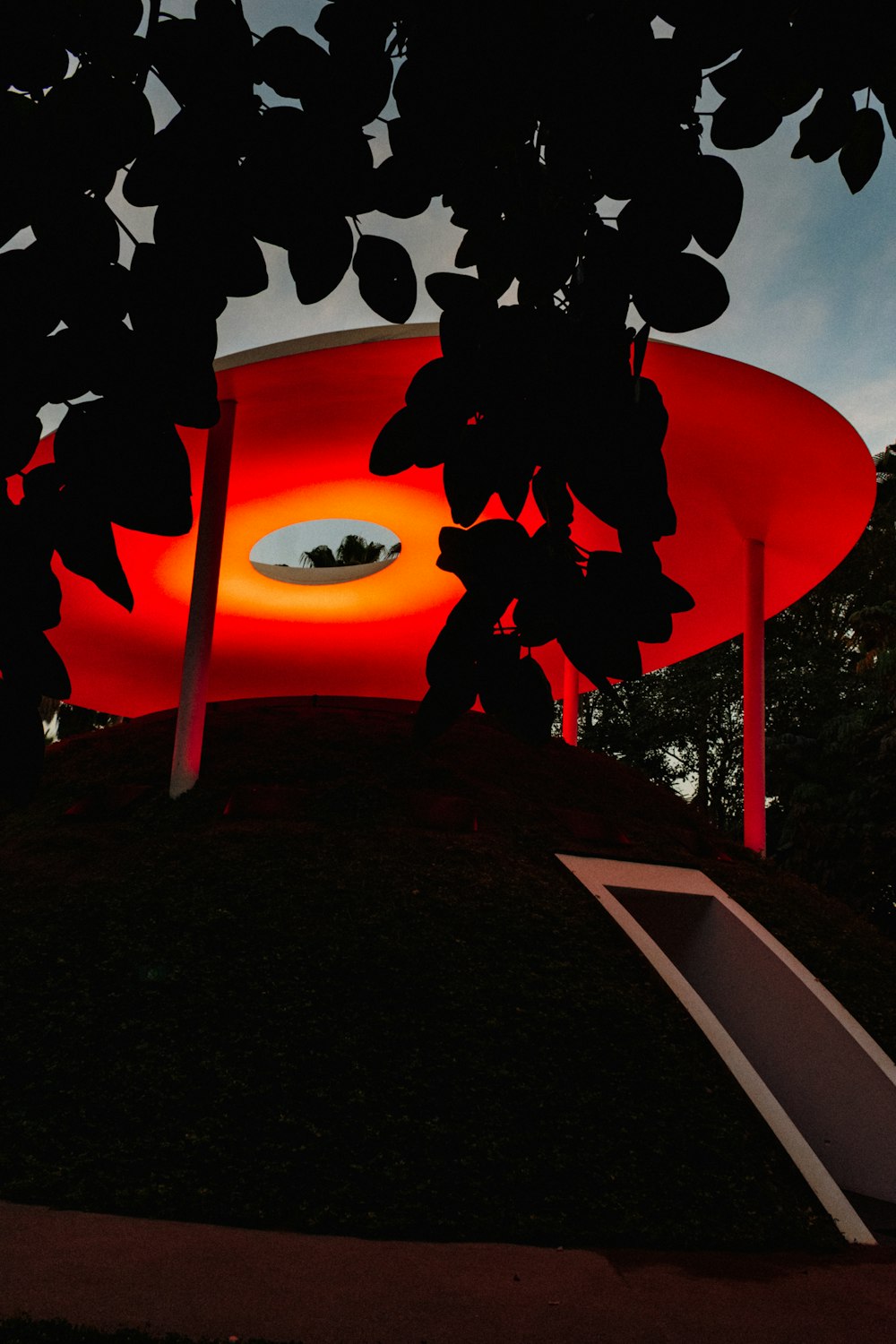 a red sign with a silhouette of a person walking on a street