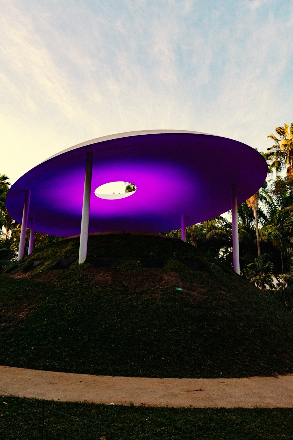 a large purple arch with a frisbee in the air