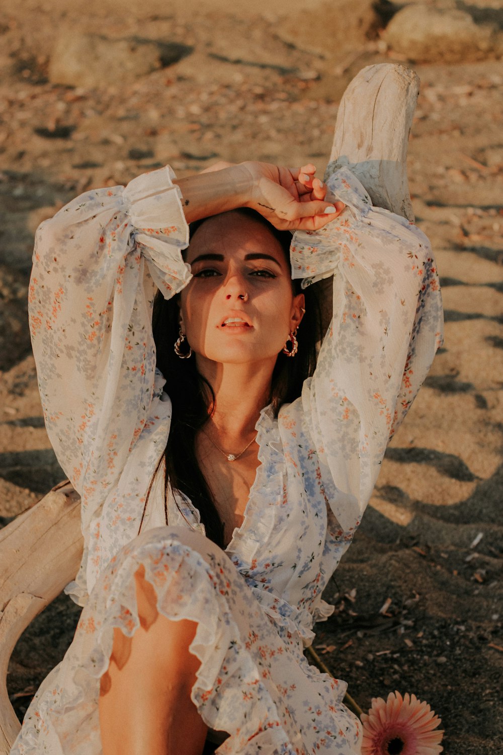 a person wearing a white dress and holding a wooden object