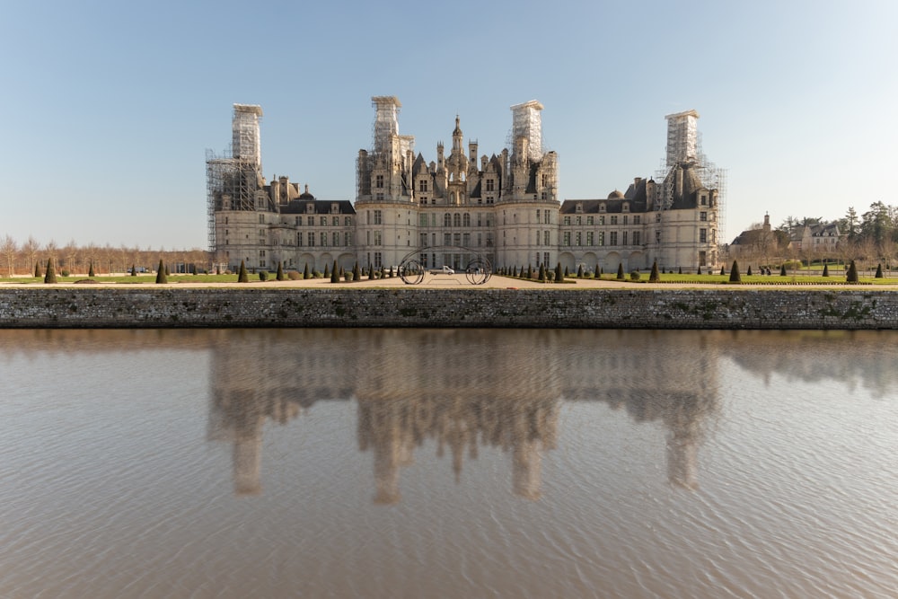 a castle on a hill by a body of water