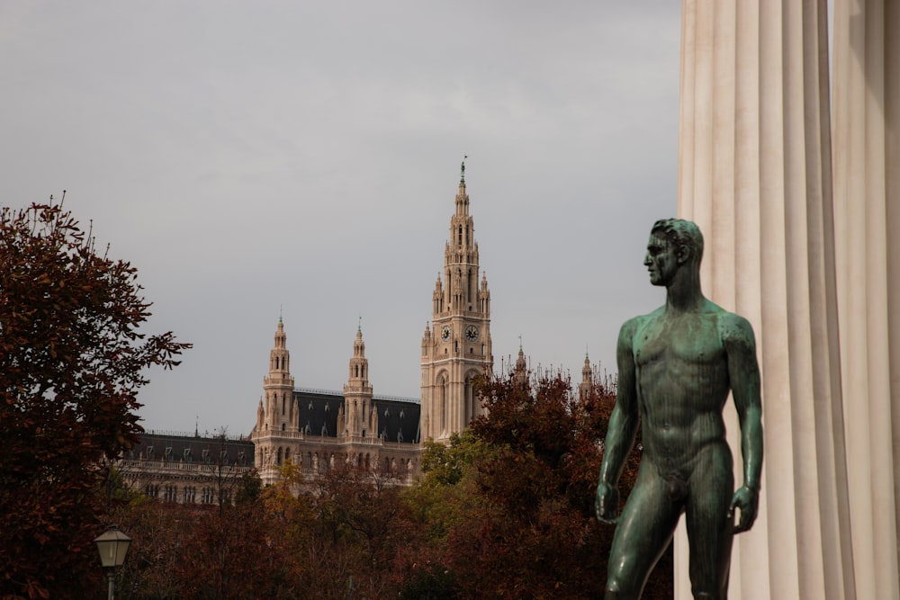 a statue of a person with a building in the background