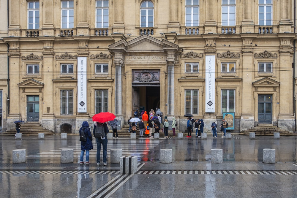 people walking in front of a building