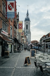 a brick street with tables and chairs