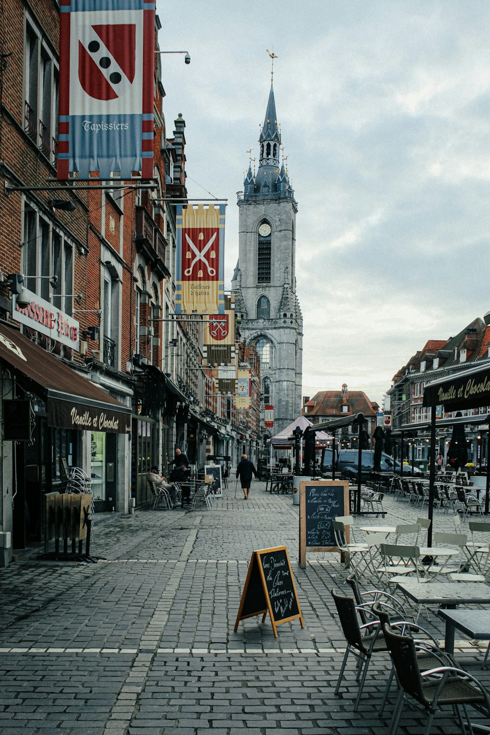 a brick street with tables and chairs