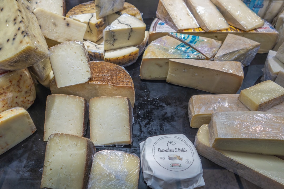 a group of cheeses, La vitrine de la gastronomie Lyonnaise dans les halles Paul Bocuse.
