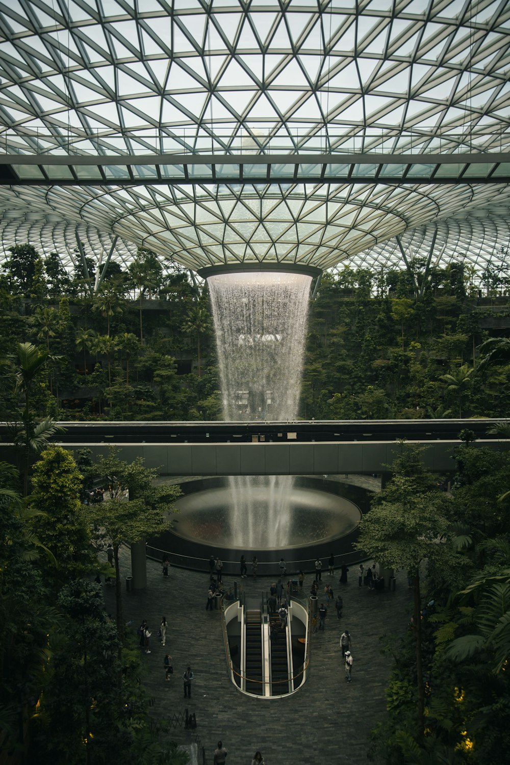 a large glass dome with people walking around