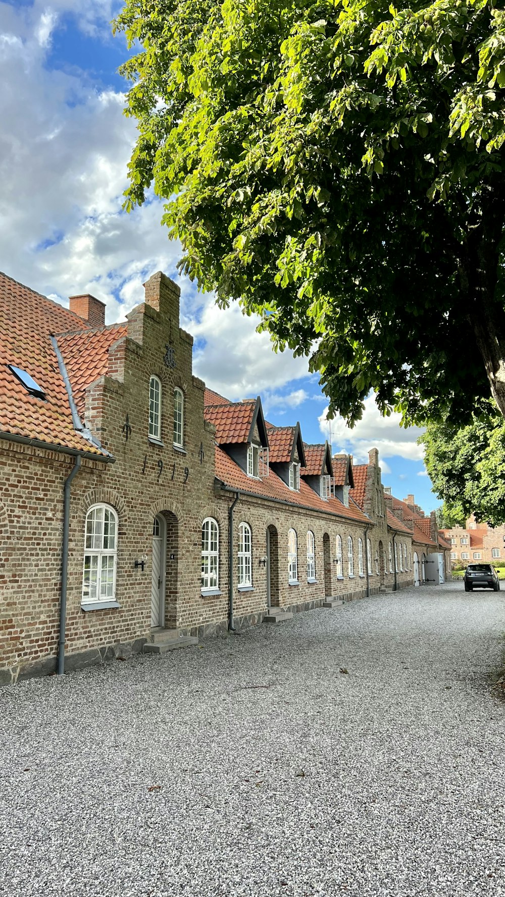 a brick building with a tree in front of it