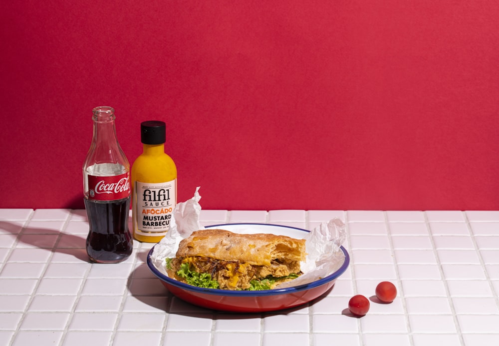 a bowl of food and bottles of alcohol on a tile floor