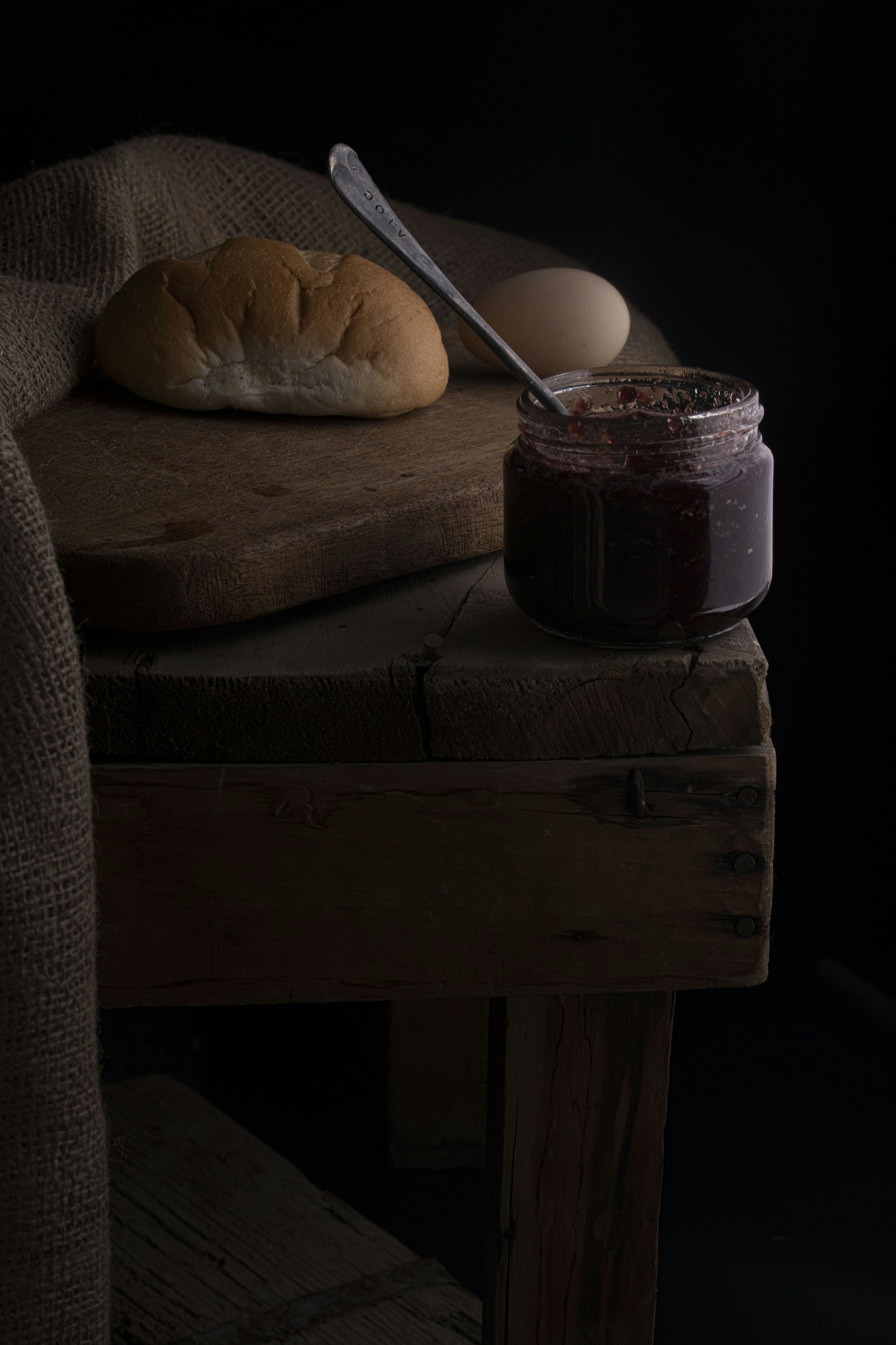 a wooden table with a spoon and a bowl of food on it