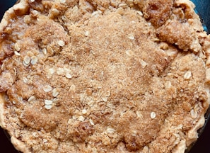 a brown pastry with white powder on it
