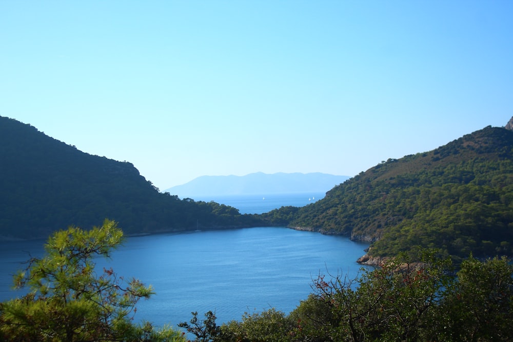 a body of water surrounded by hills