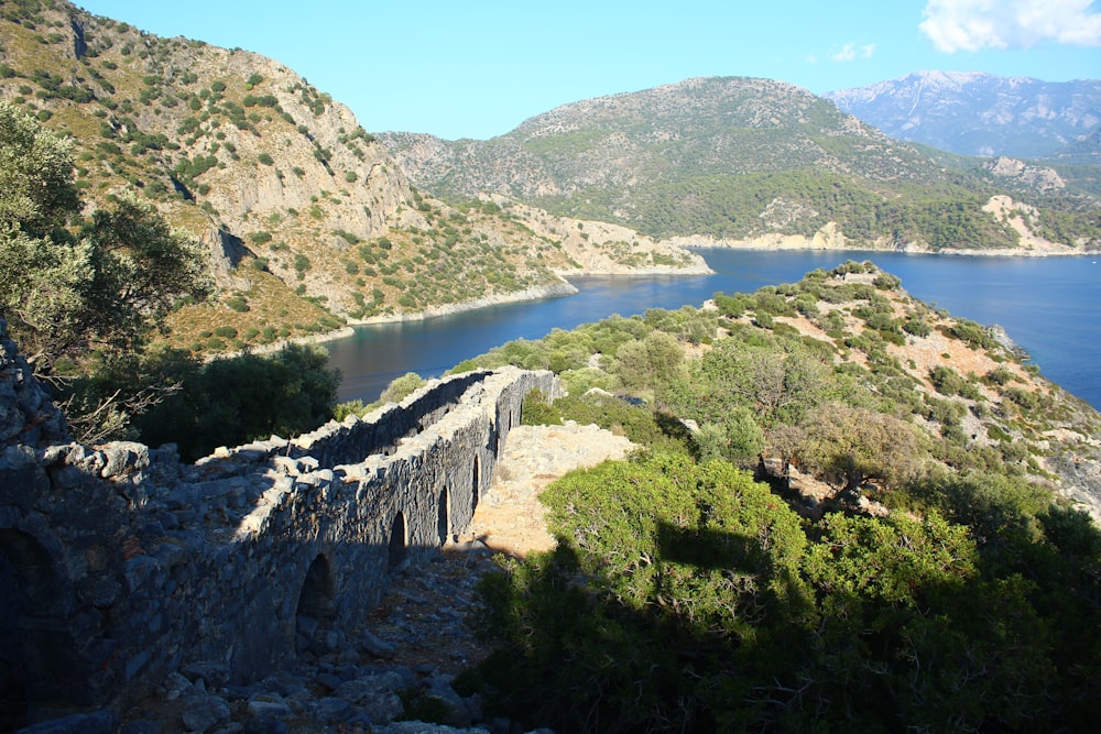 a rocky cliff with a body of water below